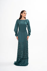 The designer gown styled, showcasing the elegant fit, long sleeves, and graceful back split
