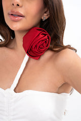 Close-up detail of the top, highlighting the texture of the ruched jersey fabric and the craftsmanship of the red floral appliqué.