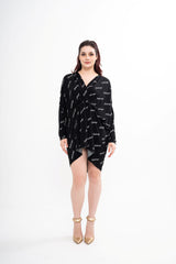 Balenciaga slip-fit mini dress for rental, featuring a black fabric with all-over Balenciaga logo print and long sleeves, photographed in Sri Hartamas, Malaysia.