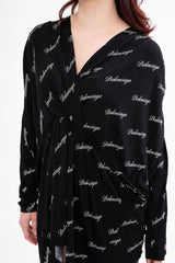 Close-up detail of the dress, highlighting the texture of the viscose fabric and the repeat logo pattern, available for rental in Kuala Lumpur, Malaysia.