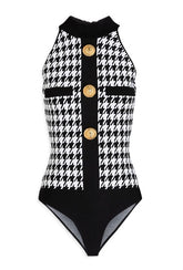 Detail of the zip fastening along the back and the snap closure at the base of the Balmain bodysuit.