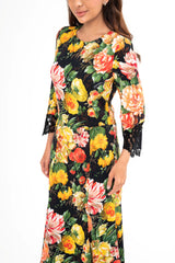 Close-up detail of the dress, highlighting the delicate lace trim and the texture of the crepe fabric.