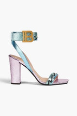 Close-up detail of the sandals, highlighting the cracked metallic lambskin leather and the logo-appliquéd eyelets.