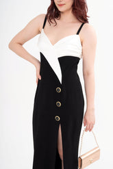 Close-up detail of the gown's bodice, highlighting the black and gold ornamented buttons and the satin fabric texture.