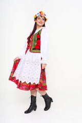 Detail of the crisp white eyelet apron and the lace-trimmed collar of the blouse.