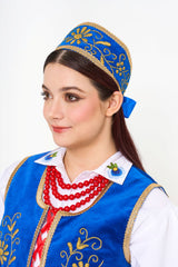 The ceremonial blue embroidered crown (headpiece) and the rich Kaszubian color palette.