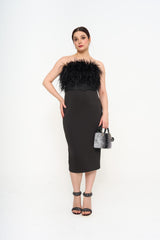 Full-length view of the gown on a model, highlighting the sculpting fit and the dynamic movement of the feather accents.