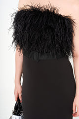 Close-up detail of the bodice, showing the texture of the ostrich feather trim and the detachable belt at the waist.