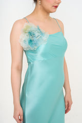 Close-up of Gucci turquoise maxi dress silk fabric and flower brooch detail rental Malaysia