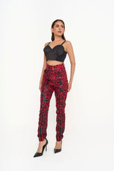 Rental Dolce & Gabbana high-rise skinny jeans in red leopard print coated twill, photographed in Sri Hartamas, Malaysia.