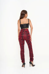 Full-length view of the red animal print jeans styled with a simple top, emphasizing the sculpted fit, available for rental in Kuala Lumpur, Malaysia