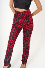 Close-up shot of the coated twill fabric, showing the glossy finish and vibrant red leopard print pattern for rental at Clarissima boutique Sri Hartamas KL