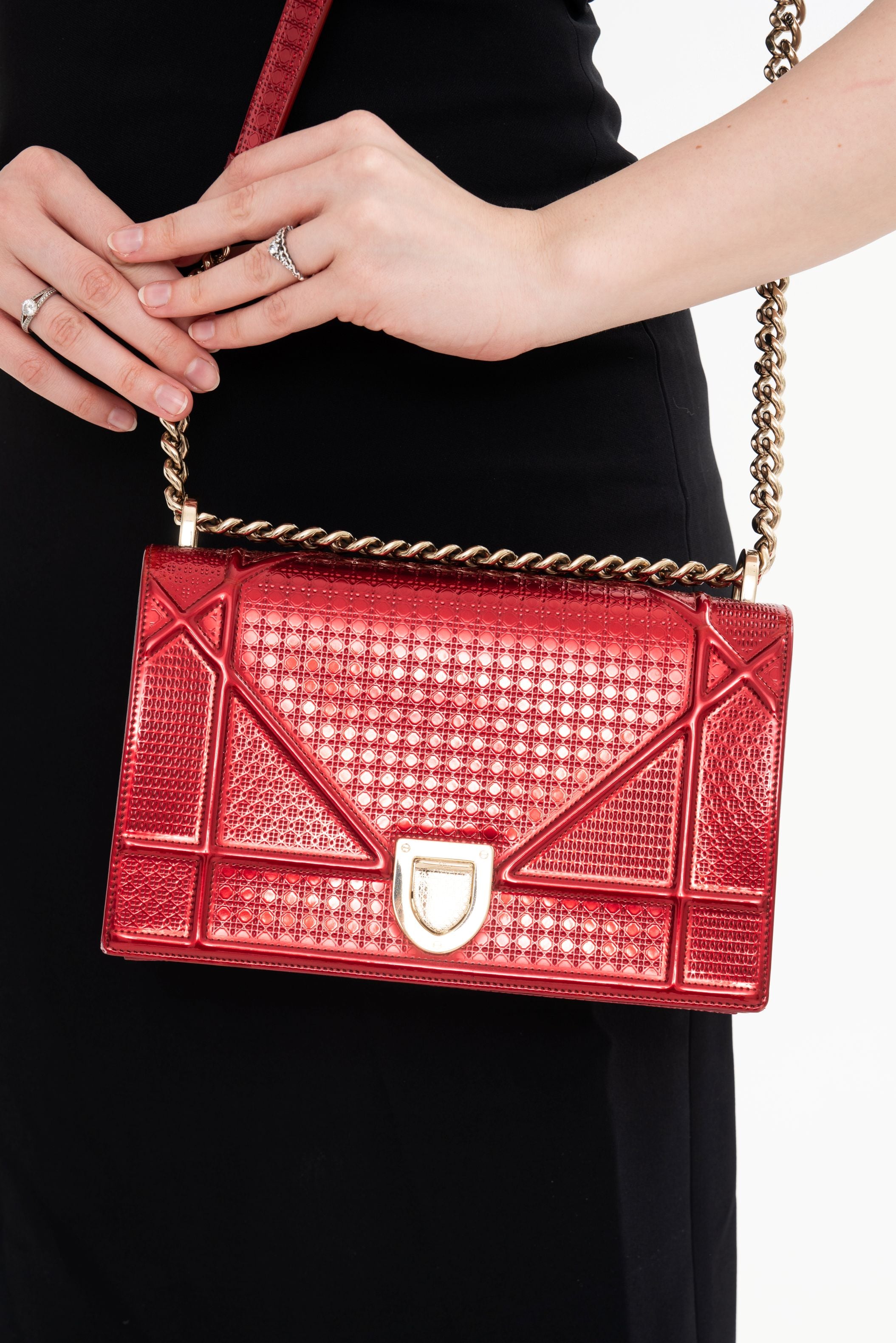 Close-up detail of the bag's surface, highlighting the unique luster and texture of the Red Patent Leather