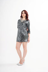 The designer dress styled, showcasing the mini length, 3/4 sleeves, and the overall sparkling silhouette.