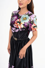 Close-up detail of the floral print, highlighting the shades of purple and the texture of the non-stretchy fabric.