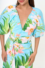 Close-up detail of the cotton-blend poplin fabric, highlighting the delicate ruching and the vibrant floral garden print.