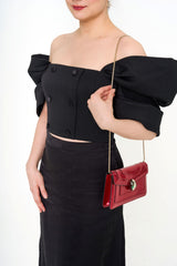 Close-up of the bustier top, showing the exquisite pleated detailing and the luxurious texture of the wool twill.