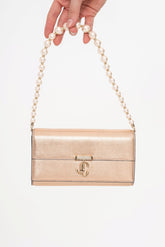 Close-up detail of the bag, highlighting the soft texture of the lamb leather and the delicate faux pearl embellishment on the chain.