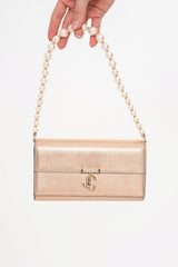 Close-up detail of the bag, highlighting the soft texture of the lamb leather and the delicate faux pearl embellishment on the chain.