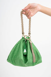 Close-up detail of the green satin clutch, highlighting the density and iridescent shimmer of the all-over crystal embellishments.