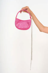 Close-up detail of the detachable enamel brooch with light-catching crystal fringe, showing the gold hardware contrast