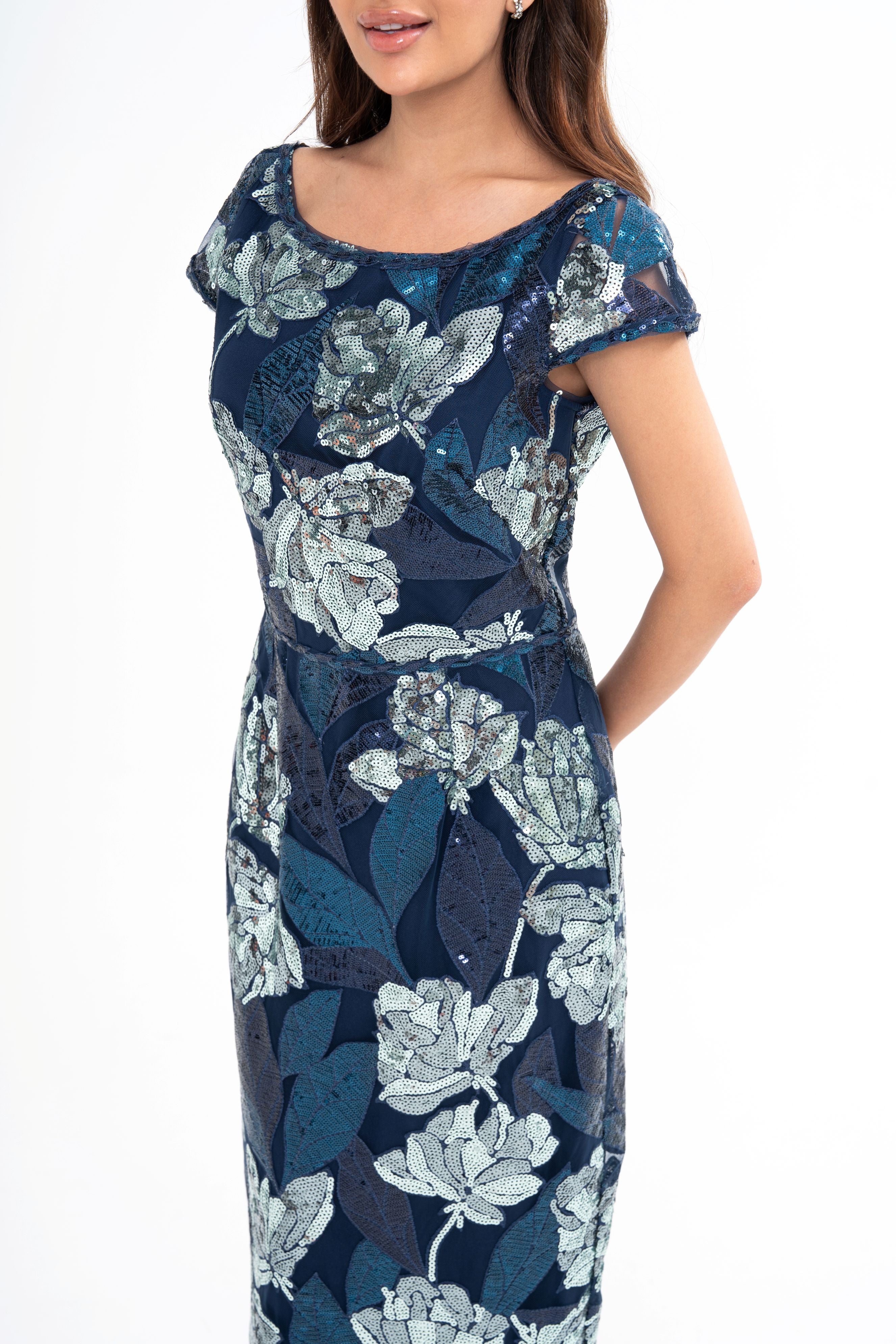 Close-up detail of the fabric, highlighting the intricate texture of the tulle and the all-over sequin embellishment.