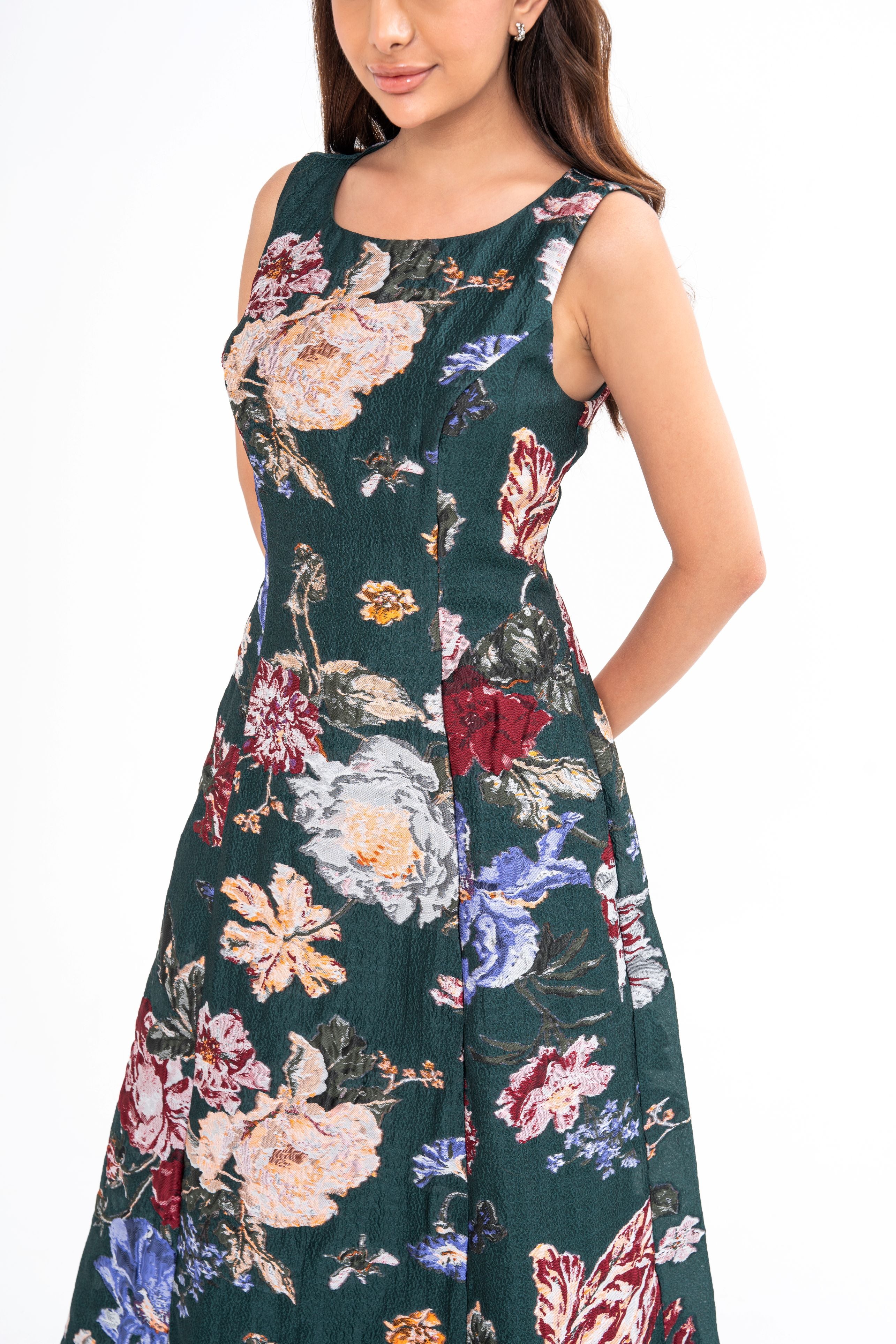 Close-up detail of the brocade fabric, highlighting its luxurious texture and the rich forest green color.