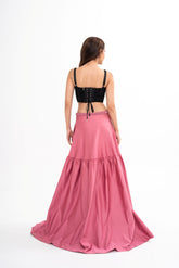 The designer skirt styled, showcasing the full-length drape and the subtle side slit pocket detail.