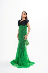 The designer gown styled, showcasing the full-length silhouette and the strategic placement of the black taffeta bow.