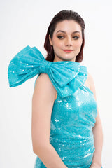 Close-up of the gown's bodice, highlighting the glistening turquoise sequin texture and the draped fabric detail of the bow, photographed in Sri Hartamas, Malaysia.