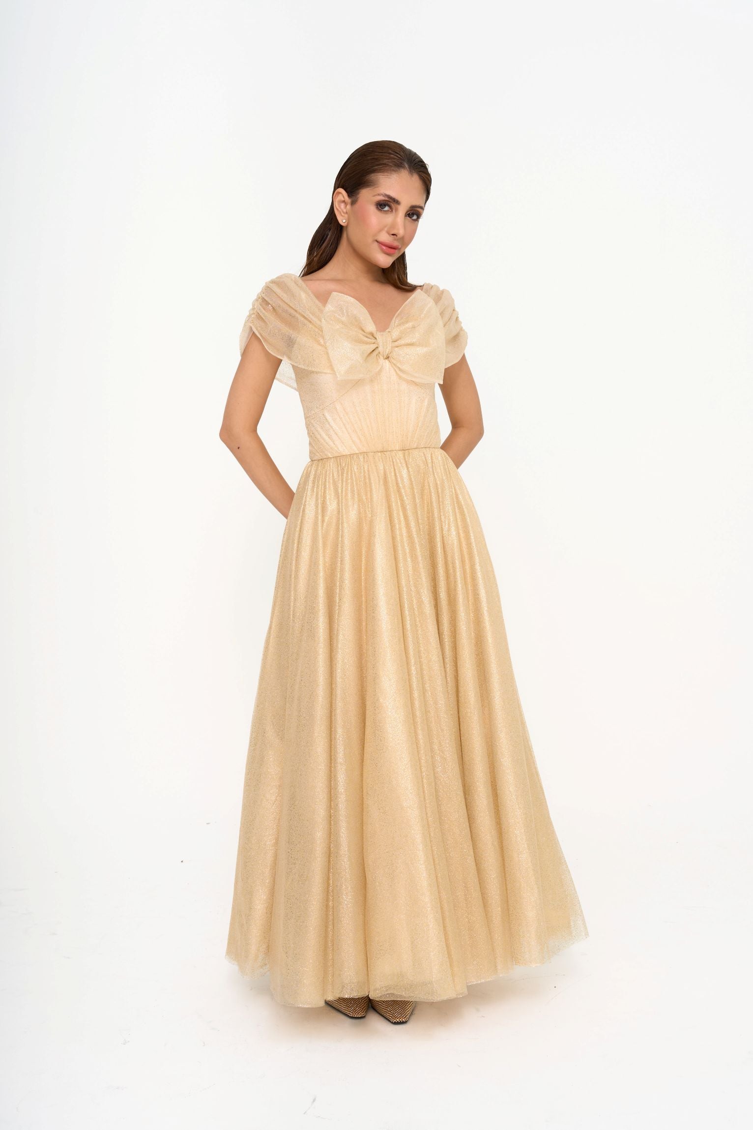 Full-length view of the gown on a model, highlighting the structured bodice with internal boning and the cascading, voluminous skirt.