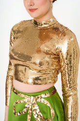 Close-up detail of the ribbed texture and shimmering sequins on the designer top.