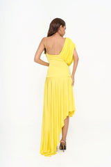 Full-length back view of the dress on a model, highlighting the fluid movement of the asymmetric hem and the fitted waist.