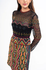 Close-up detail of the dress, highlighting the intricate beadwork, metallic trim, and ethnic-inspired embroidery on the semi-sheer fabric.