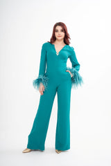 Valentino silk jumpsuit for rental in turquoise blue-green, featuring ostrich feather trim and gold VLogo plaque, photographed in Sri Hartamas, Malaysia.