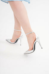 Valentino Garavani silver leather heels for rental, featuring a 100mm stiletto heel and rhinestone-embellished ankle strap, photographed in Sri Hartamas, Malaysia.