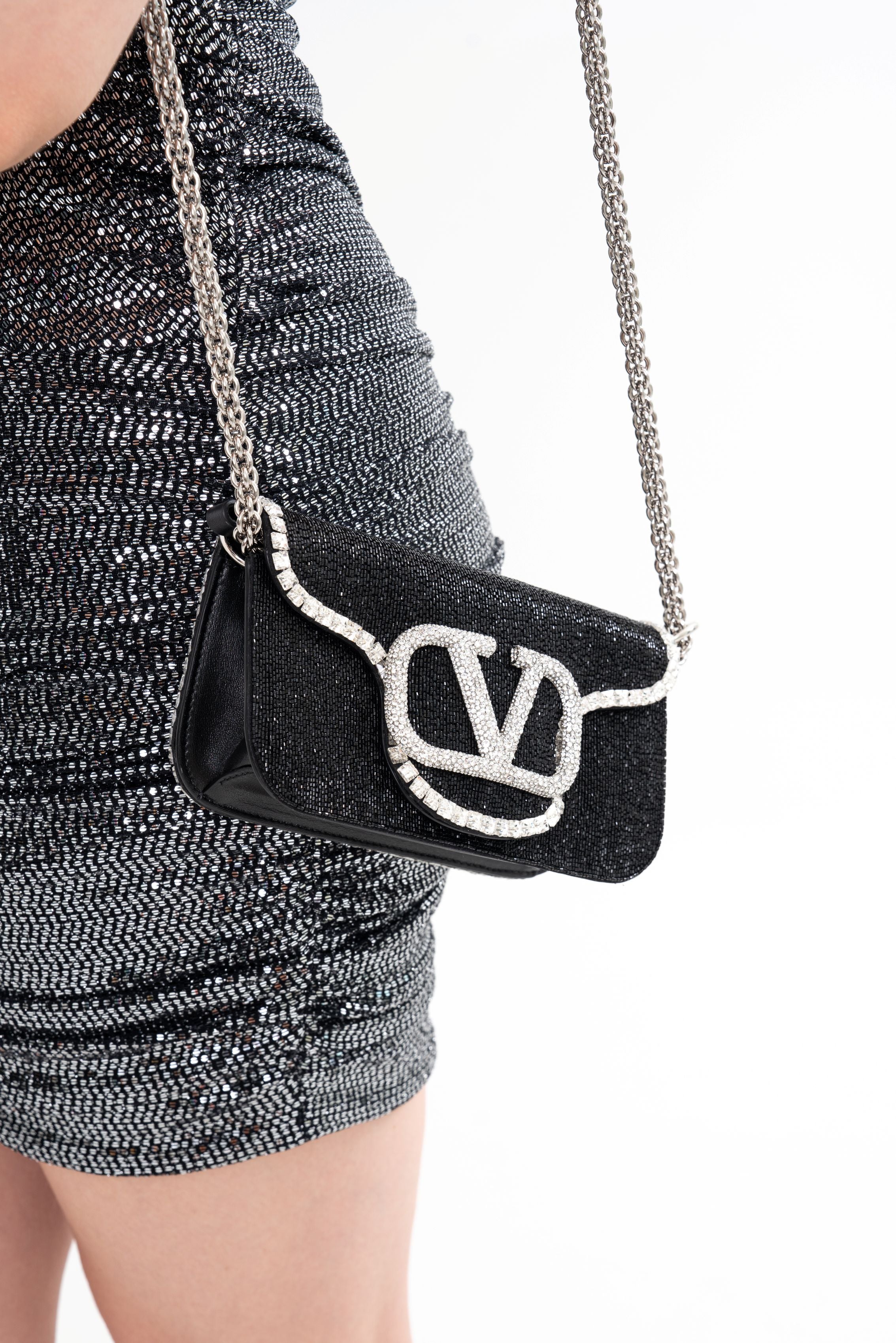 Close-up detail of the bag, highlighting the gem-encrusted VLogo and the texture of the all-over glass bead and crystal trim.