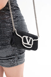 Close-up detail of the bag, highlighting the gem-encrusted VLogo and the texture of the all-over glass bead and crystal trim.