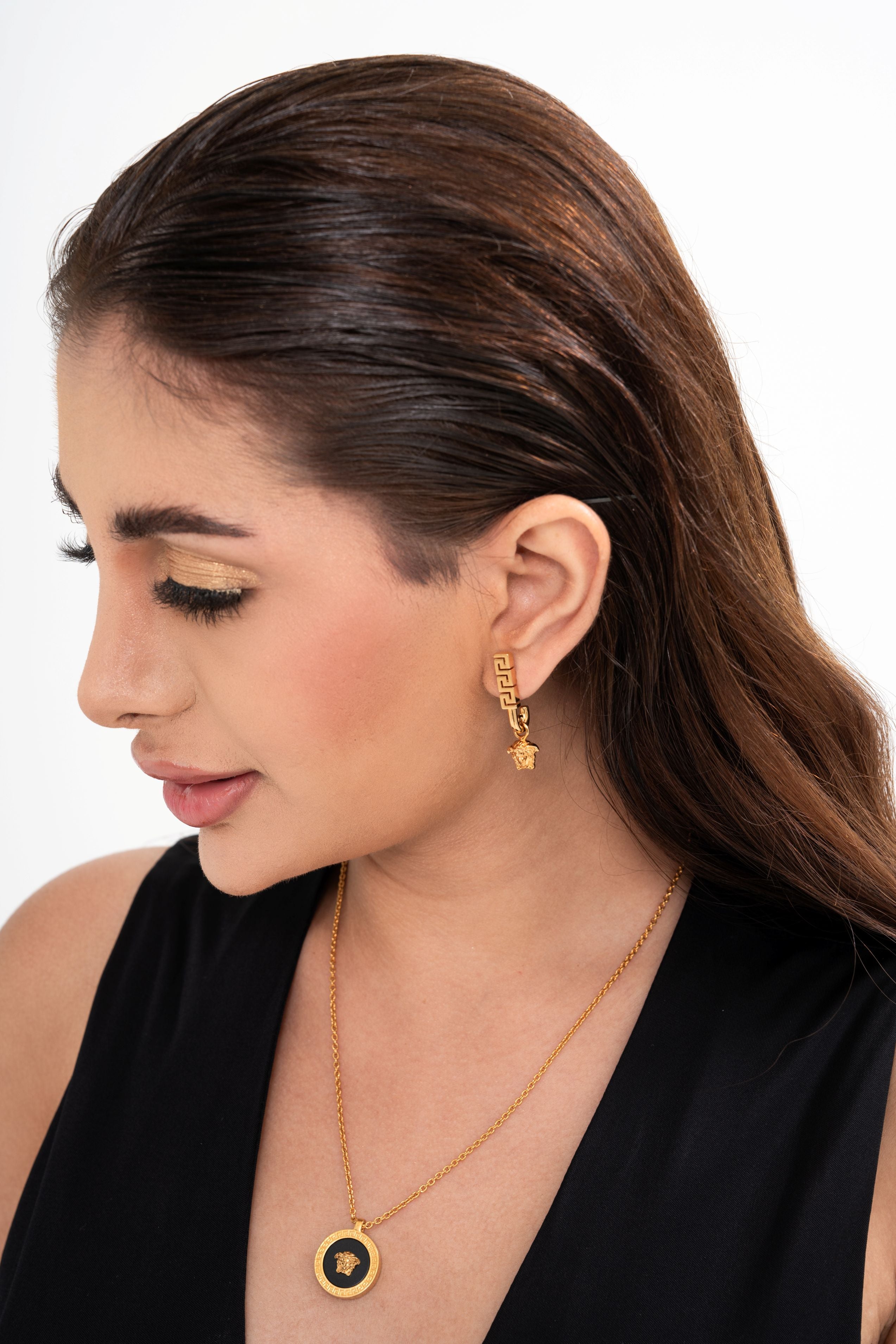 Versace gold-toned brass necklace for rental, featuring a round enamel Medusa pendant with Greca engraving, photographed in Sri Hartamas, Malaysia.