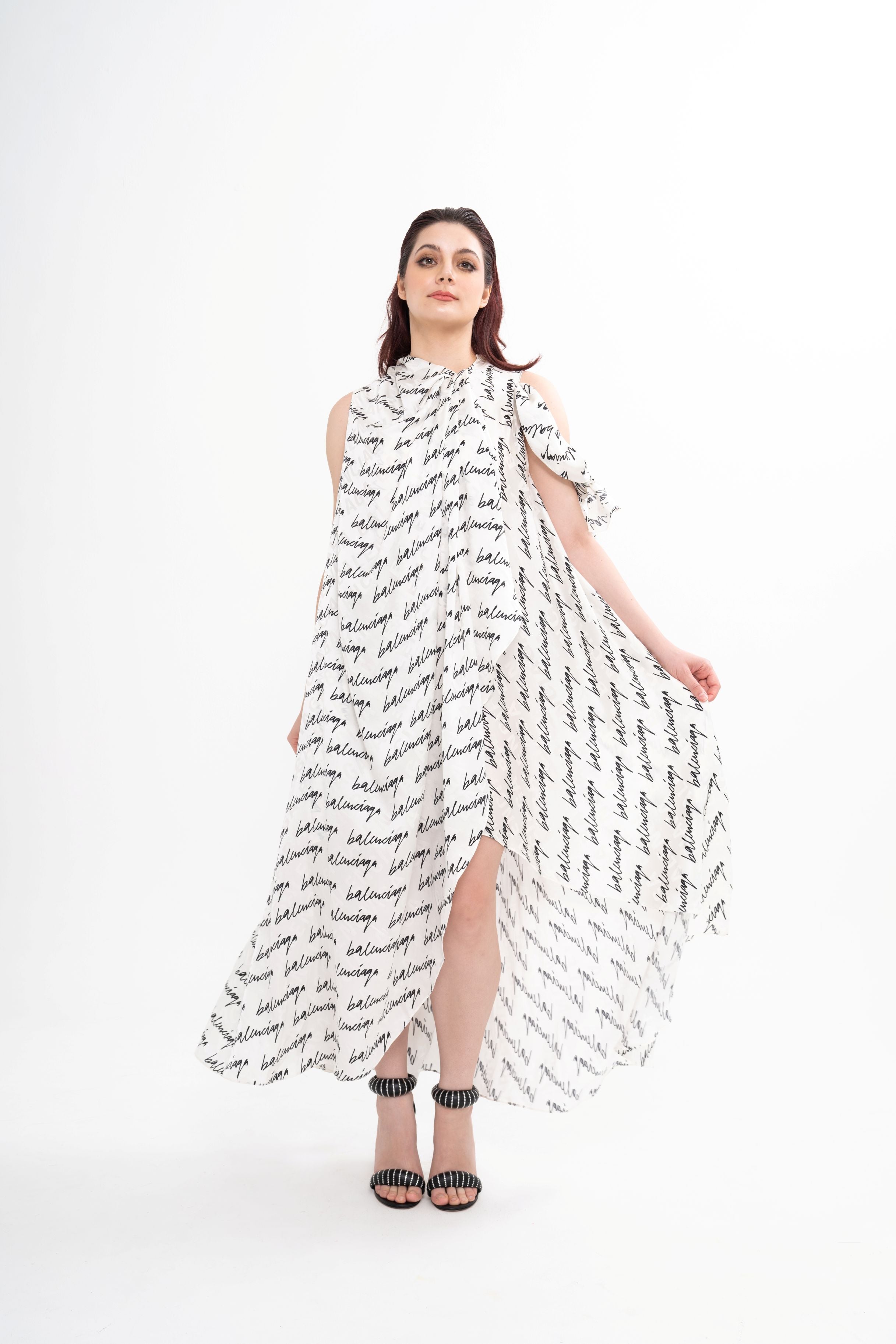 Balenciaga silk draped dress for rental, featuring all-over logo print and an asymmetrical silhouette, photographed in Sri Hartamas, Malaysia.