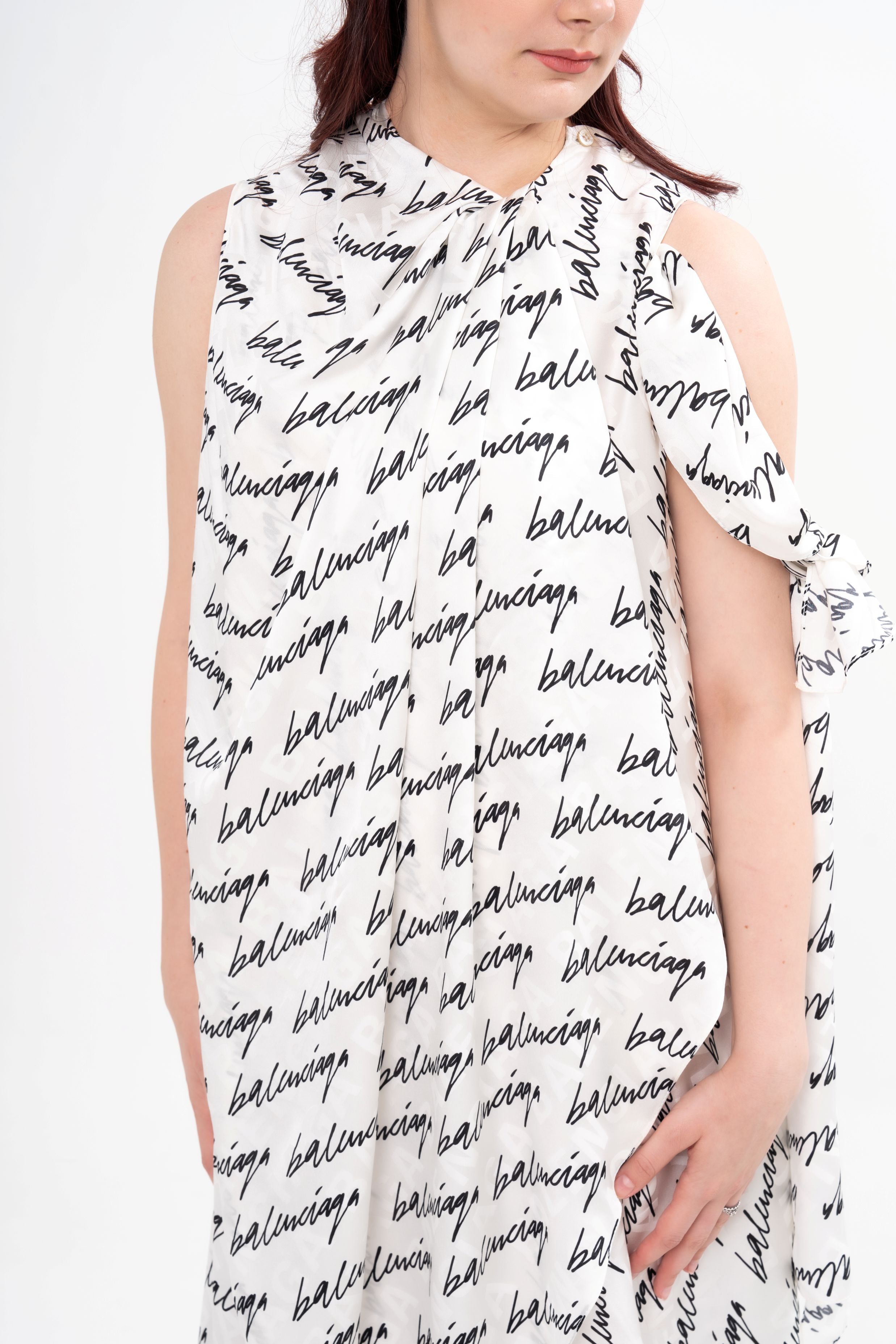 Close-up detail of the pure silk fabric, highlighting the fluid texture and the repeat Balenciaga logo print