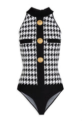 Detail of the zip fastening along the back and the snap closure at the base of the Balmain bodysuit.