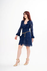 The designer dress styled, showcasing the midi length, flattering silhouette, and the ruffled lace accents.