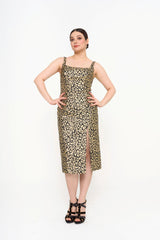 The dress styled on a model, showcasing the slim, sculpted fit and the dramatic movement created by the front split.