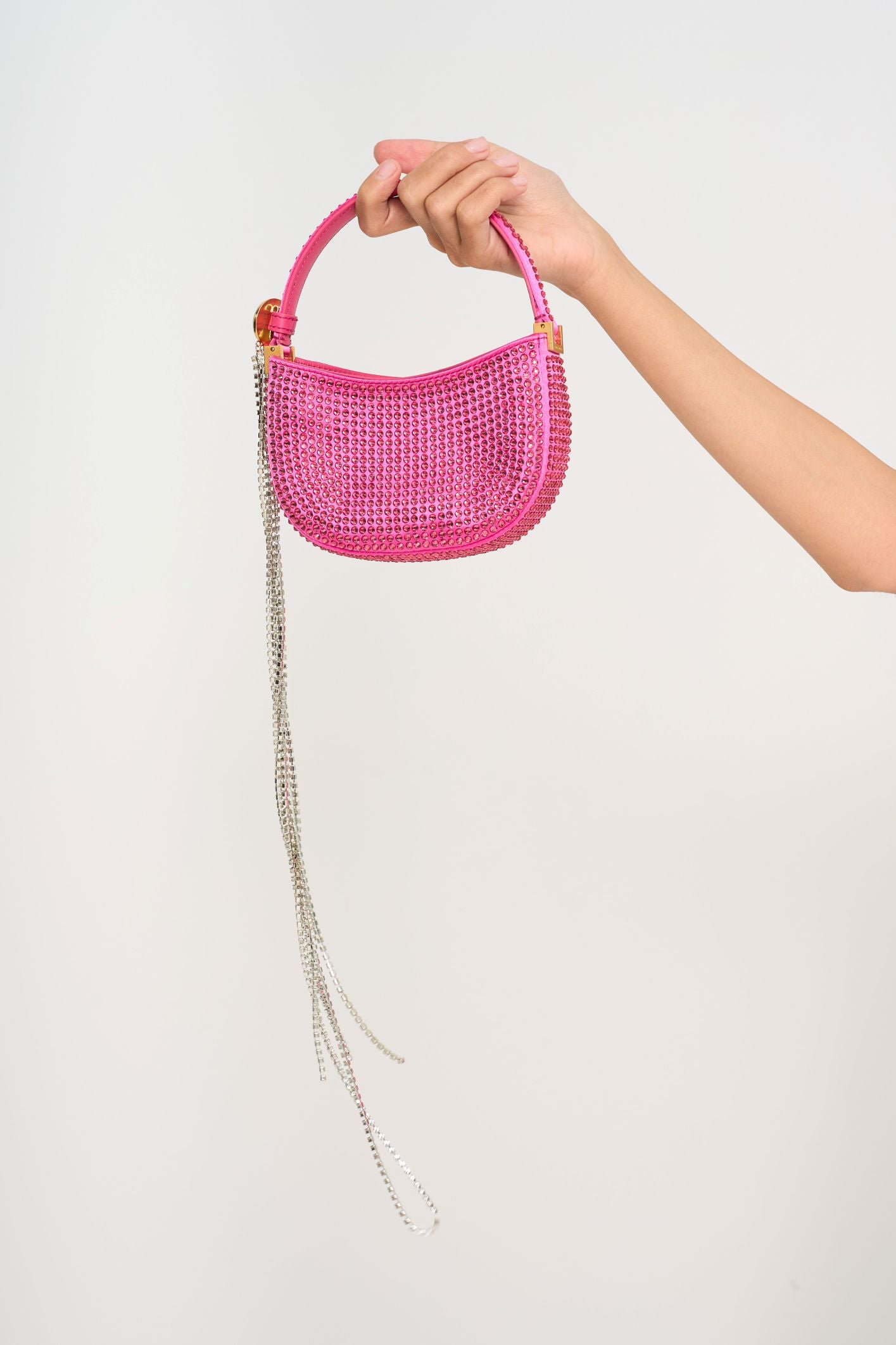 The fuchsia crystal Magda Butrym bag styled as a statement accessory, emphasizing its compact size and high-glamour finish, available for rental in Kuala Lumpur, Malaysia