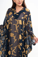 Close-up detail of the gown, highlighting the semi-sheer silk fabric and the shimmering gold floral fil coupé texture.